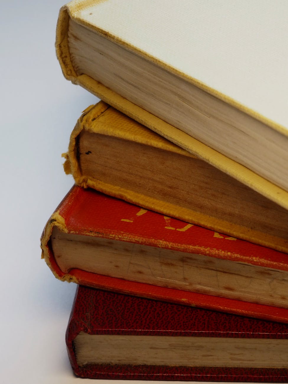 four assorted color hardbound books